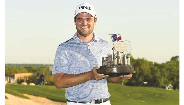 Corey Conners of Canada poses with the trophy after winning the 2019 Valero Texas Open at TPC San Antonio Oaks Course in San Antonio on Sunday.