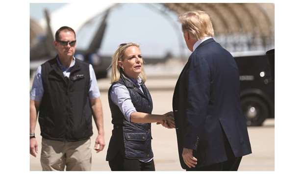 President Donald Trump shakes hands with Homeland Security Secretary Kirstjen Nielsen near the US-Mexico border in El Centro, California, on April 5.