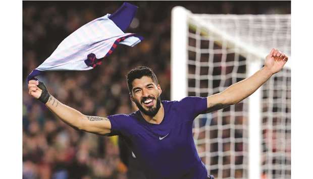 Barcelonau2019s Luis Suarez celebrates his goal during the La Liga match against Atletico Madrid at the Camp Nou stadium in Barcelona on Saturday. (AFP)
