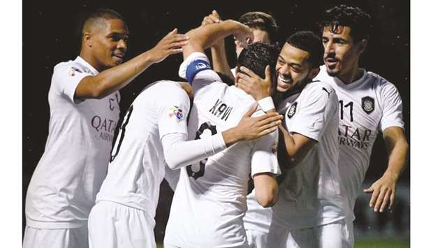 Al Sadd star Xavi is congratulated by teammates after he scored against Uzbekistanu2019s Pakhtakor in Tashkent yesterday. The match ended in a 2-2 draw.