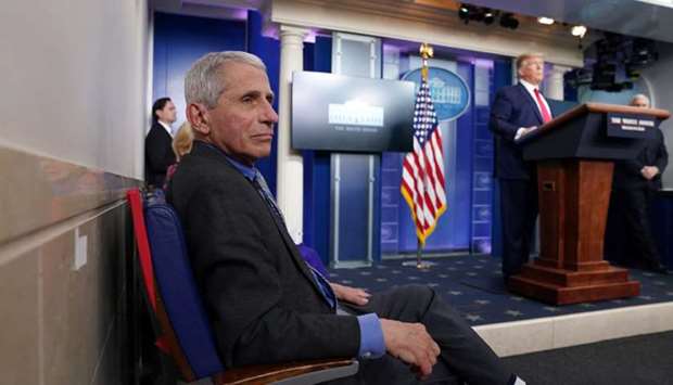 Dr Fauci listens as Trump addresses the daily coronavirus task force briefing at the White House.