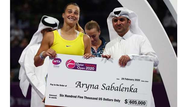 Belarusu2019 Aryna Sabalenka is presented with a cheque after winning the Qatar Total Open 2020 at the Khalifa International Tennis and Squash Complex in Doha on February 29, 2020. (Reuters)