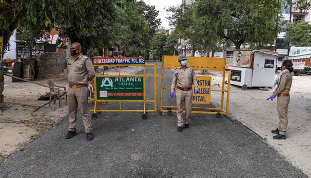 Police personnel stand guard at the sealed entry-exit of sector-2B, Vasundhara, Ghaziabad, following the Uttar Pradesh governmentu2019s decision to seal hotspots in 15 coronavirus-hit districts yesterday.