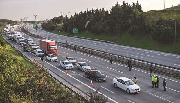 A Turkish health official checks the temperature of a driver at a check point on the Asian side entry of Istanbul on Monday. The government is rushing assistance at a time hundreds of thousands of businesses remain shut down because of the Covid-19 outbreak.