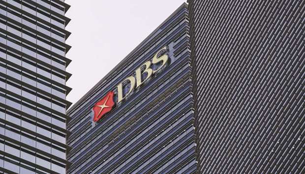 The DBS Group Holdings logo is displayed atop Tower 3 of the Marina Bay Financial Centre in Singapore.