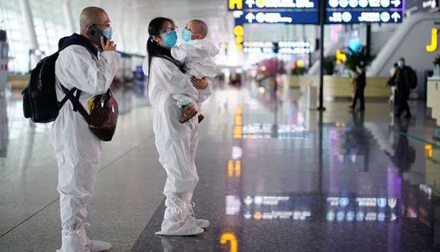 Travellers in protective suits are seen at Wuhan Tianhe International Airport after the lockdown was lifted in Wuhan, the capital of Hubei province and Chinau2019s epicentre of the novel coronavirus disease outbreak, yesterday.