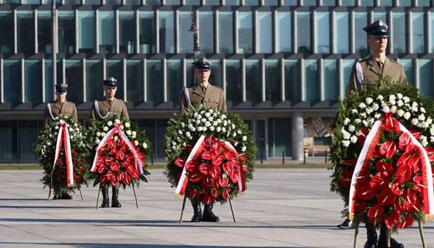 Soldiers carry wreaths in front on the monument in Warsawu2019s Pilsudski Square to the victims of the Smolensk air disaster, marking the 10th anniversary of the crash of the Polish government plane in Smolensk, Russia, that killed 96 people.