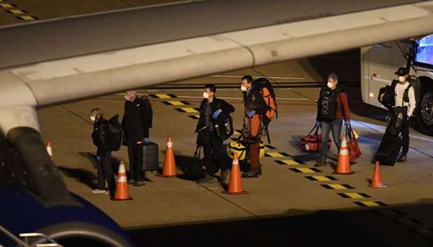 Covid-19-free passengers evacuated from the coronavirus-stricken Australian liner Greg Mortimer board the medically equipped plane that will fly Australian and New Zealander passengers to Melbourne, at Carrasco International Airport early today.