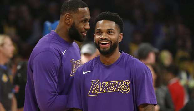 The Los Angeles Lakersu2019 LeBron James (left) and Troy Daniels talk during warm-ups ahead of a game against the Minnesota Timberwolves at Staples Center in Los Angeles on December 8, 2019. (Getty Images/TNS)