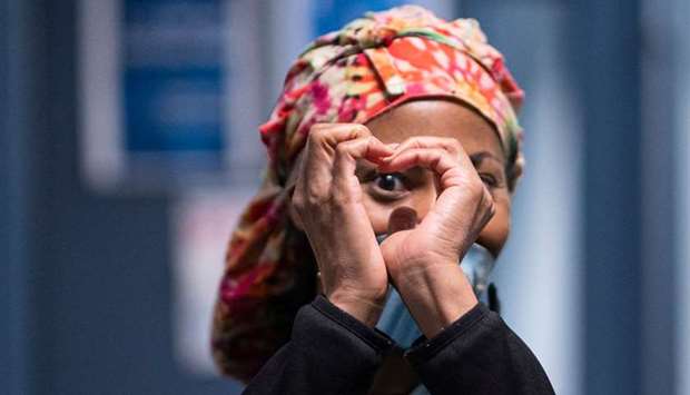 A healthcare worker forms a heart inside the temporary hospital located at the USTA Billie Jean King National Tennis Center during the outbreak of the coronavirus disease, in the Queens borough in New York City.