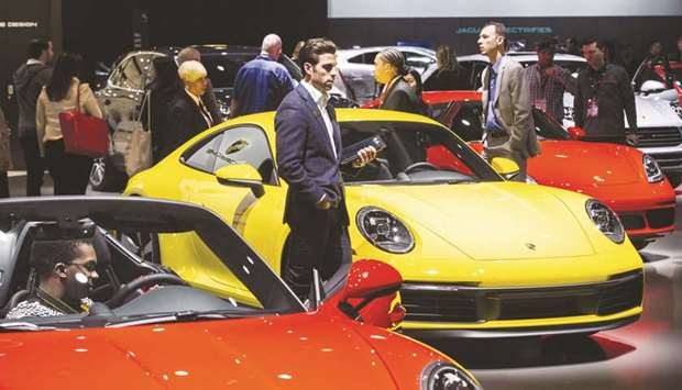 Attendees view Porsche 911 Speedster vehicles displayed during the 2019 New York International Auto Show.