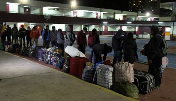 Bolivian citizens stranded in Chile after the border was closed as preventive measure against the coronavirus disease outbreak, arrive at a shelter in Iquique.