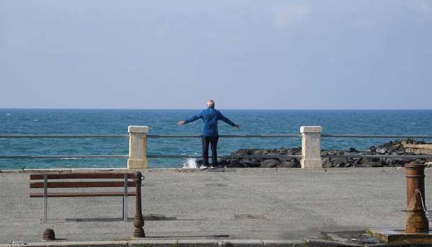 A man stands in front of the sea, during the coronavirus disease (COVID-19) outbreak, in Ostia, near Rome, Italy April 13, 2020.