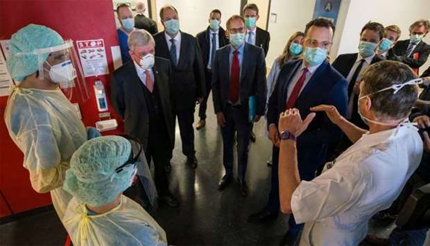 German Health Minister Jens Spahn, Hesse Minister of Social Affairs Kai Klose, German Chancellery's Chief of Staff Helge Braun and Hesse's State Premier Volker Bouffier talk to intensive care unit nurse Lena Mueller and ward physician Bjoern Kemmering during their visit to the University Hospital of Giessen and Marburg in Giessen, Germany