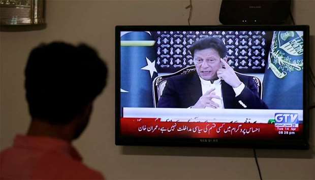 Prime Minister Khan is seen on a television screen, announcing the extension of the country-wide lockdown by two weeks, due to the ongoing spread of the coronavirus disease.