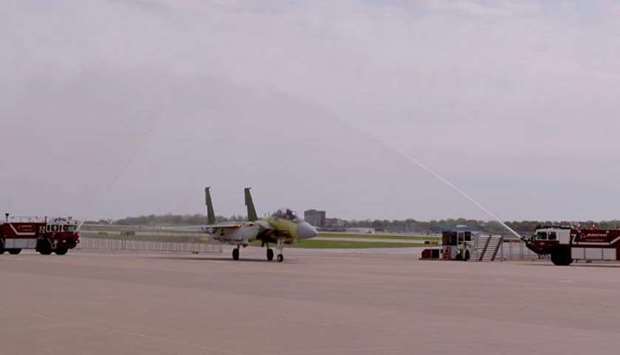 A F-15 fighter developed for the Amiri Air Force is welcomed with a water cannon salute at a US base