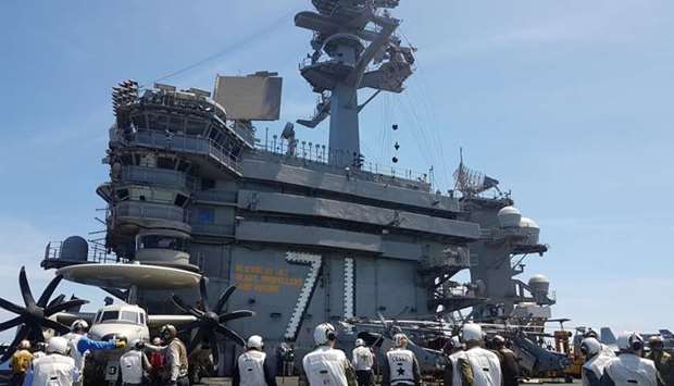 A busy day on the flight deck of the USS Theodore Roosevelt while transiting the South China Sea April 10, 2018