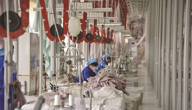 Chinese employees work on manufacturing products that will be exported to the US at a factory in Binzhou in Chinau2019s eastern Shandong province (file).