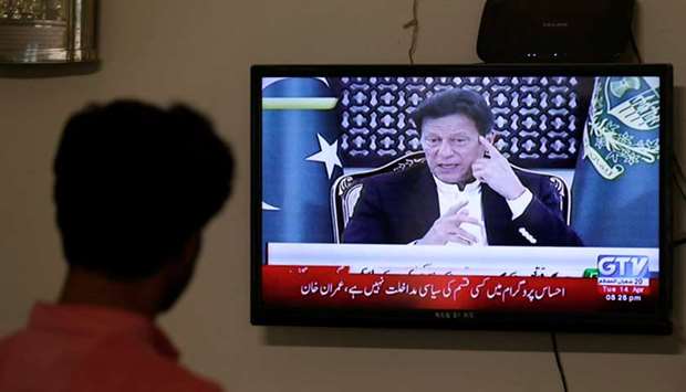 Prime Minister Khan is seen on a television screen, announcing the extension of the country-wide lockdown by two weeks, due to the ongoing spread of the coronavirus disease.