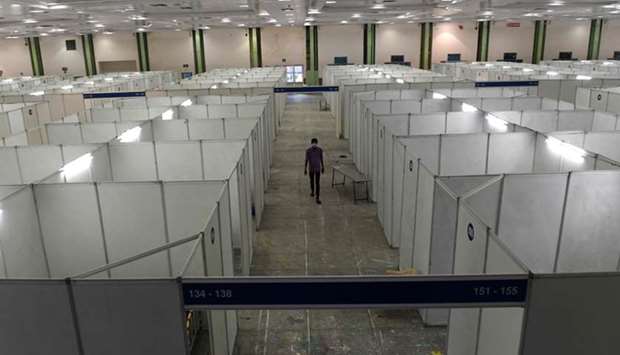 A health worker walks inside the Chennai trade centre, which is being converted into an isolation ward with the capacity of 600 beds, yesterday.
