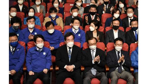 Lee Nak-yon (centre front), South Koreau2019s former prime minister and candidate of the ruling Democratic Party, and his party members watch television screens showing the result of exit polls of the parliamentary elections at a hall of the National Assembly in Seoul yesterday. South Koreau2019s left-leaning ruling Democratic party was heading towards a parliamentary majority in the general election, exit polls showed, as voters backed President Moon Jae-inu2019s handling of the coronavirus epidemic.
