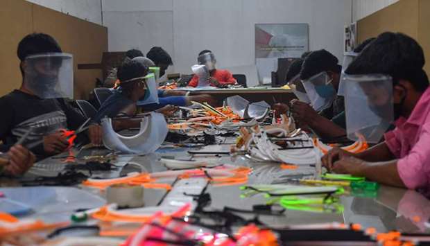 Staff prepare face shields for local authorities at the Folds Design Studio in Navi Mumbai yesterday.