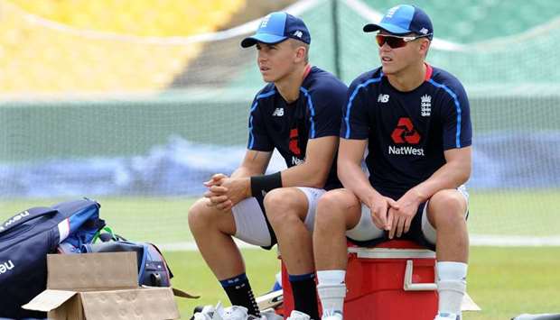 In this file photo taken on October 08, 2018, brothers Tom Curran (left) and Sam Curran take rest during a practice session at the Rangiri Dambulla International Cricket Stadium in Dambulla. (AFP)