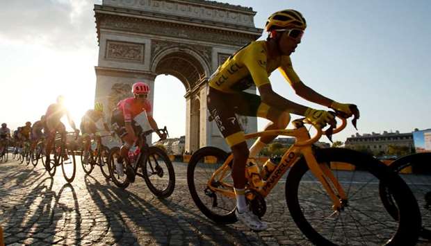 In this July 28, 2019, picture, Team INEOS rider Egan Bernal (right) of Colombia rides in the overall leaderu2019s yellow jersey in the final stage of the Tour de France in front of the Arc de Triomphe in Paris, France. (Reuters)