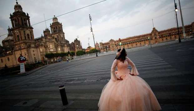 A girl has her quinceanera pictures taken in Zocalo Square amid the outbreak of the coronavirus disease (COVID-19), in Mexico City
