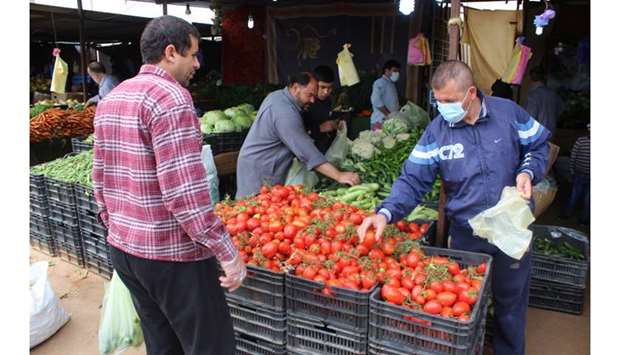 People buy vegetables from the shop before the curfew, following the outbreak of the coronavirus disease in Misrata, Libya, yesterday.