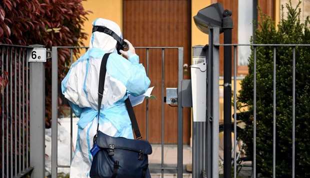 A doctor in protective suit visits the home of a person suffering from the coronavirus disease (Covid-19) in Bergamo, the epicentre of Italy's outbreak
