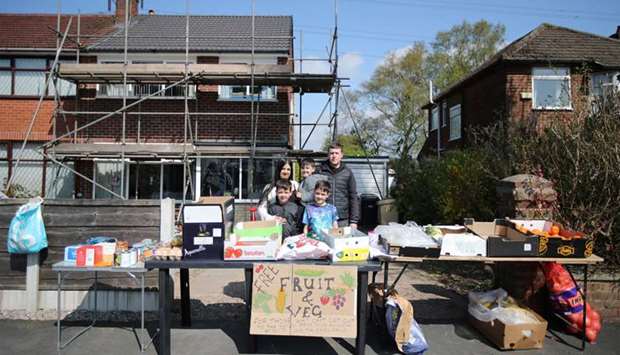 Angela and Martin Barry pose with sons, Joshua (9), Ben (7) and Isaac (4) after setting up a free fruit and vegetable stall for elderly people as the spread of the coronavirus continues in Bolton, yesterday.