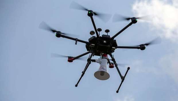 A Rwandan police drone fitted with a megaphone speaker flies in a residential neighbourhood to enforce a lockdown in Kigali.