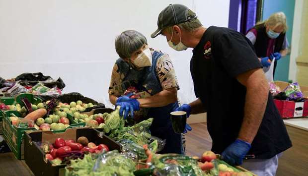 Masked church volunteers organise food donations before distributing them to those in need, an approved essential service during the spread of the coronavirus disease, at One1Seven evangelical Anglican church in Sydney, Australia, yesterday.