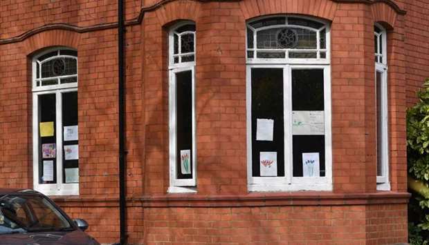 Messages of support for the residents are displayed in the windows of Peel Moat care home in Stockport, Greater Manchester, northwest England, on April
