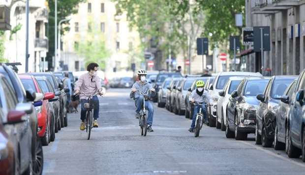 People ride their bicycles, amid the coronavirus disease outbreak, in Milan, Italy