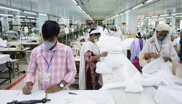 Bangladeshi garment workers make protective suit at a factory amid concerns over the spread of the coronavirus disease (COVID-19) in Dhaka, Bangladesh