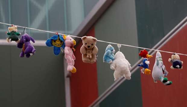 Stuffed toys hang between buildings in Ronda, southern Spain. Under the pandemic lockdown measures, children must stay at home.