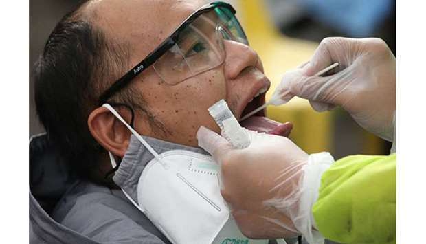 A rapid swab test for the coronavirus disease 2019 is administered to a man at the Sta. Ana Hospital in Manila.