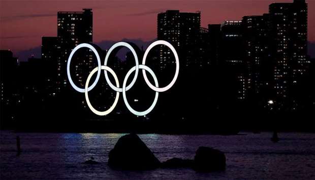 The giant Olympic rings are seen in the dusk at the waterfront area at Odaiba Marine Park in Tokyo