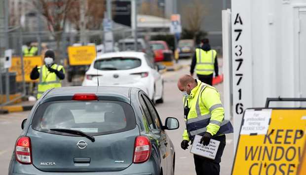 People queue in their cars at an NHS coronavirus disease self test site outside the 02 Arena, as the spread of the coronavirus disease continues, in London, Britain, yesterday.