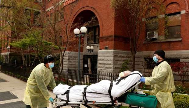 Emergency Medical Technicians (EMTs) wheel a man out of the Cobble Hill Health Center nursing home during an ongoing outbreak of the coronavirus disease in the Brooklyn borough of New York