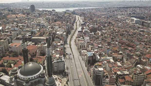 An aerial picture shows a general view of iconic Taksim square and Tarlabasi street of Istanbul on Sunday, as the Turkish government announced a two-day curfew to prevent the spread of the epidemic Covid-19 caused by the novel coronavirus.