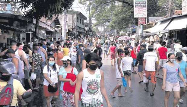 People crowd a market in Barangay Holy Spirit in Quezon City, despite repeated calls by government to observe physical distancing to arrest the Covid-19 infection.