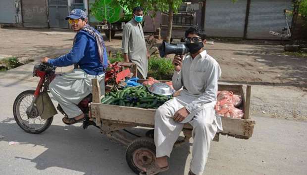 Vendors sell vegetables along a street during a government-imposed nationwide lockdown against the Covid-19 coronavirus on the outskirts of Islamabad yesterday.