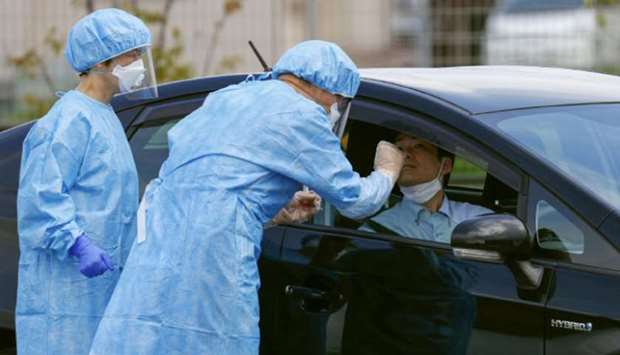 Medical workers carry out a mock drive-through testing for the coronavirus disease in Nara, Japan.