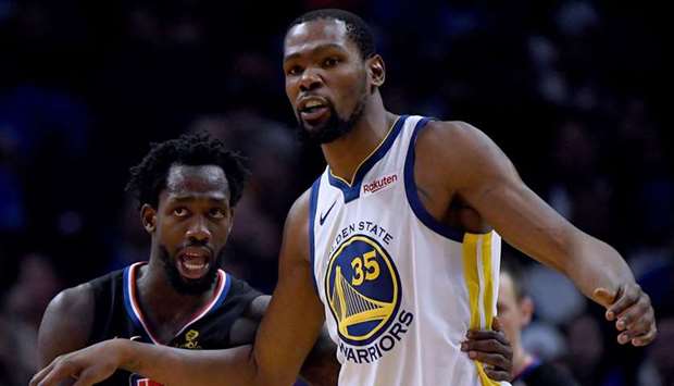 File photo of Kevin Durant (right) of the Golden State Warriors and Patrick Beverley of the LA Clippers in action during a regular NBA match at Staples Center. (TNS)