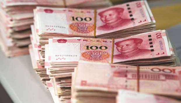 Chinese currency notes at a bank in Shanghai. The Qatar Renminbi Centre allows Qatari establishments to directly access Chinau2019s onshore RMB, foreign exchange, and capital markets.