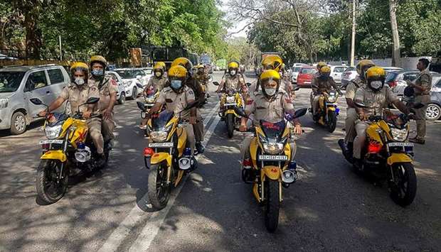 Members of the new u2018Covid Patrolu2019, a police patrol created to spread awareness and to enforce the government-imposed nationwide lockdown are seen during its launch in the south districts of New Delhi yesterday.