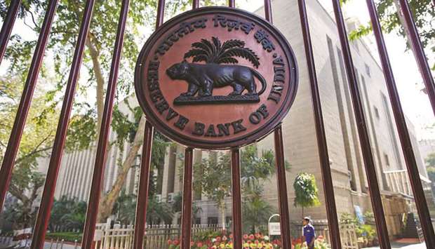 The Reserve Bank of India logo is displayed on a gate at the central banku2019s headquarters in New Delhi. The RBI may be reducing its intervention in the currency markets as volumes improve and volatility eases.